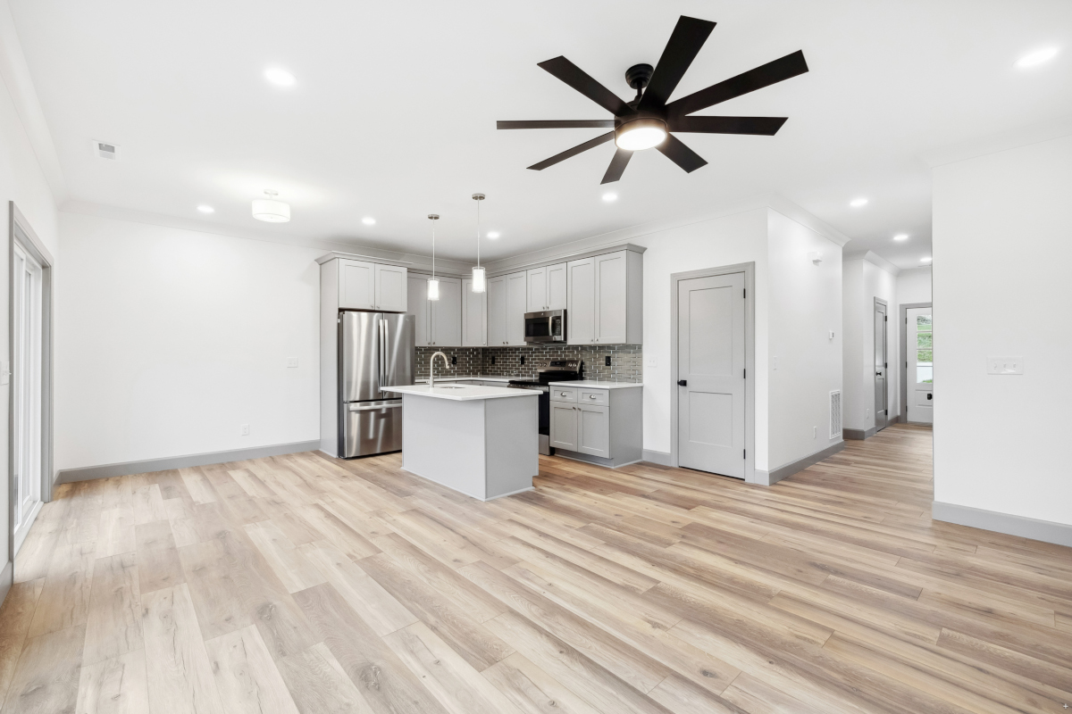 Renovated open-concept kitchen with custom cabinetry and a large island